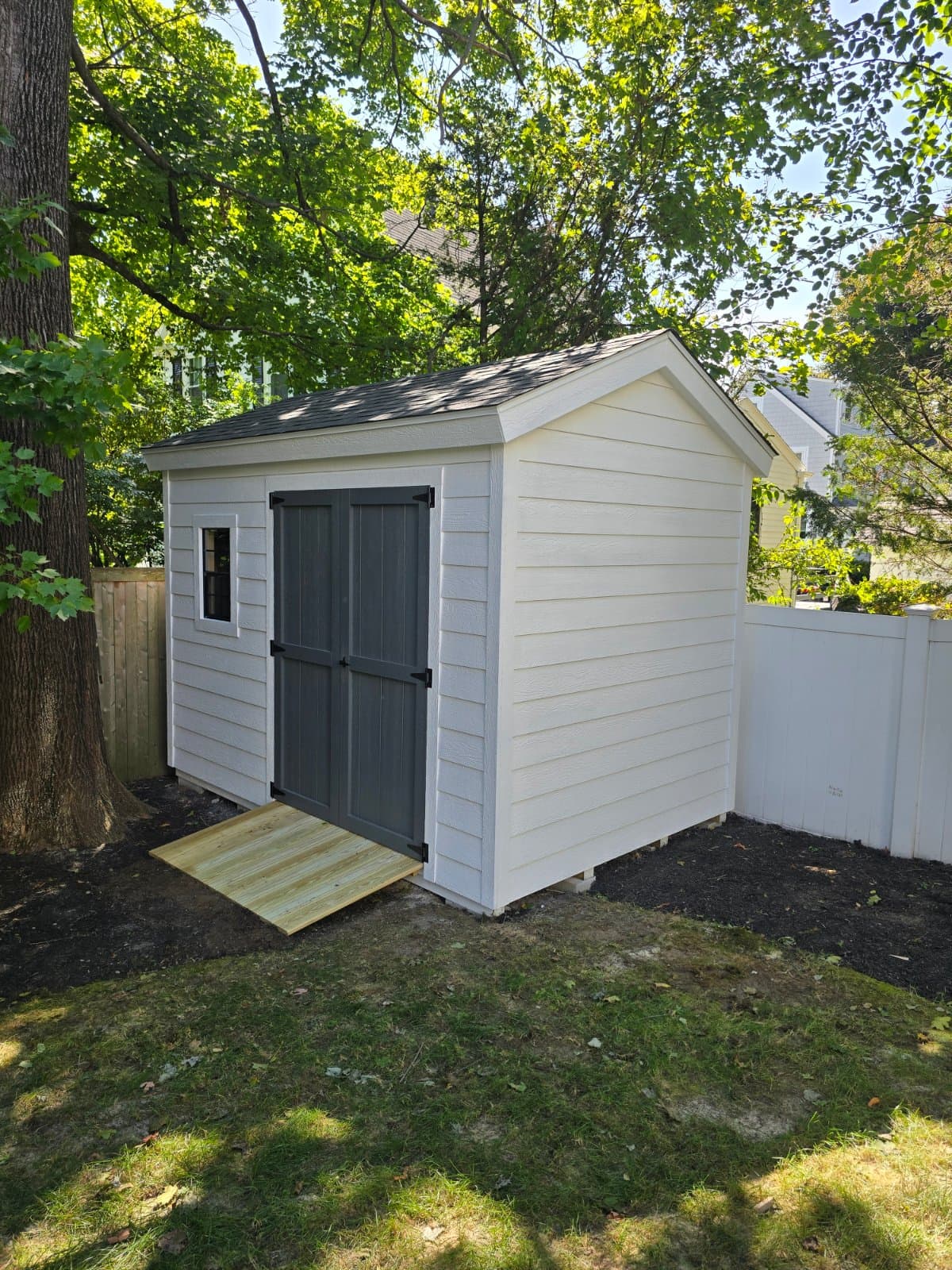 A real 8x12 Tall Traditional with clapboard siding, built onsite in Wellesley, MA